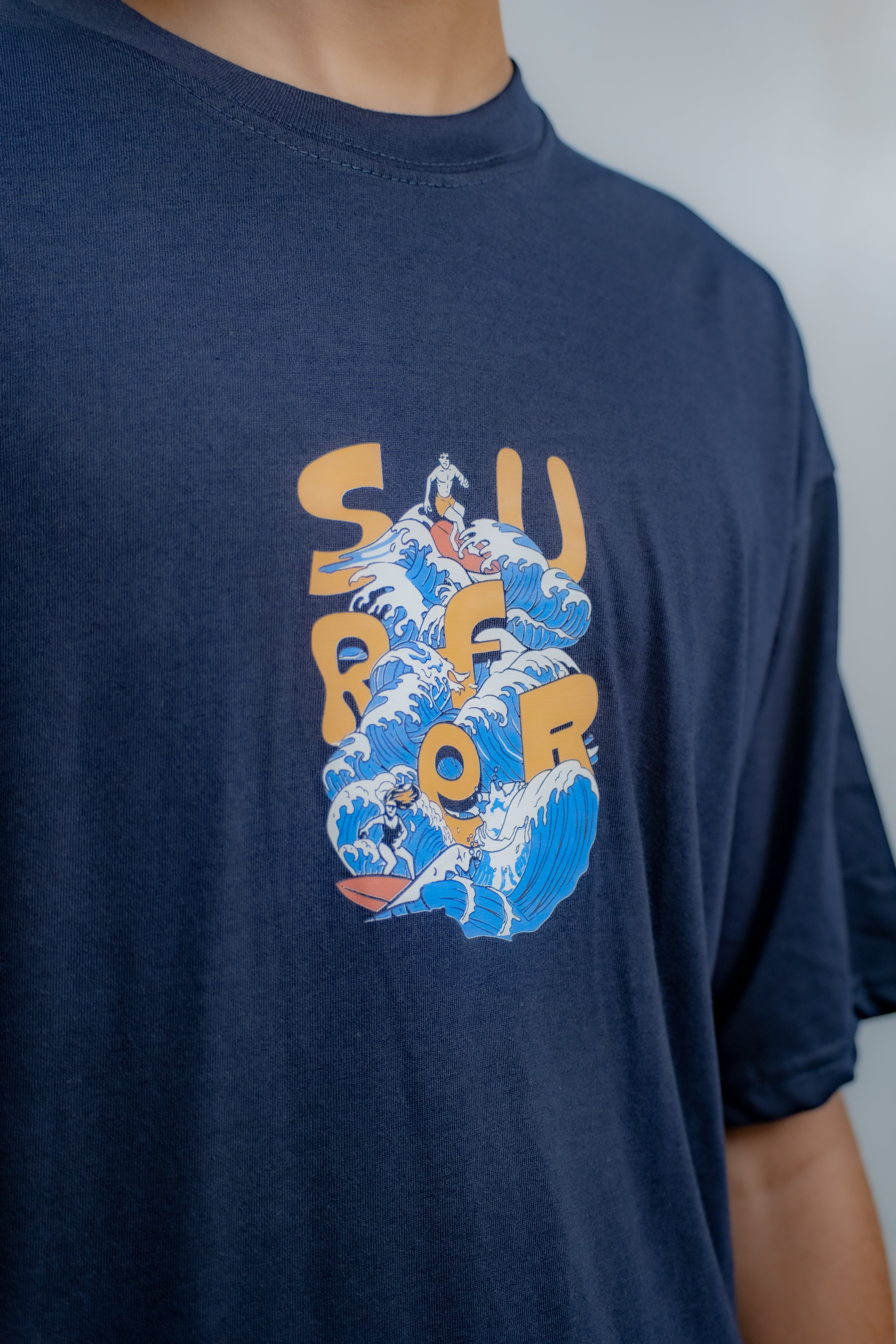 Navy blue t-shirt with 'Surf' graphic design on a plain background