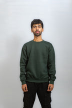 Man wearing a green sweatshirt against a plain background